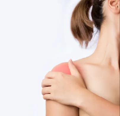 Person holding painful shoulder with red highlight, depicting condition linked to Shoulder Replacement Surgery in India.